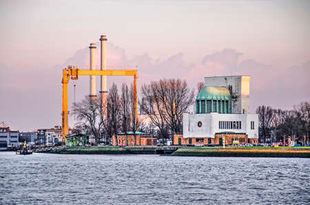 Rotterdam, The Netherlands, March 19, 2019: early evening view of the monumental Maastunnel ventilation building at the bank of the river Nieuwe Maasのeditorial素材