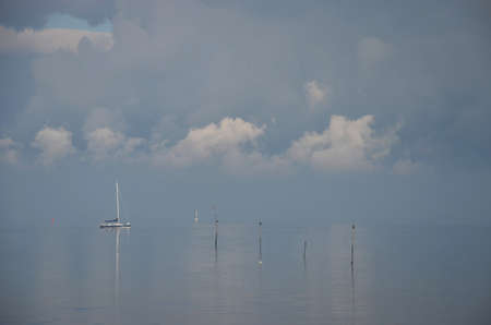 Minimalist image of a hazy day at Oosterschelde estuary, the Netherlands with a little sailing...