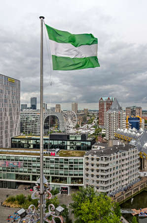 Rotterdam, The Netherlands, September 8, 2018: the green-white-green city flag with in the background Markthal, Saint Lawrence church and the cube housesのeditorial素材