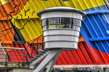 Haarlem, The Netherlands, June 24, 2017: bridge keeper's cabin of the Langebrug across the Spaarne river, against the colorful underside of the opened bridge deckのeditorial素材