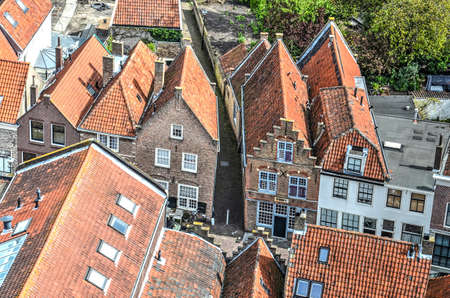 Brielle, The Netherlands, May 11, 2015: looking down at a street in the old town lined with old brick houses with red tiled roofsのeditorial素材