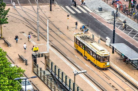 Rotterdam, The Nehterlands, June 16, 2019: aerial view of historic yellow tramway carriage on the tracks at downtown Eendrachtplein squareのeditorial素材