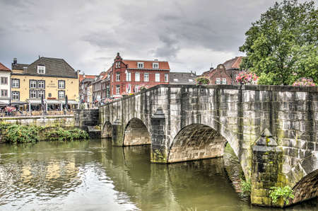 Roermond, the Netherlands, July 12, 2019: view of the river Roer, 18th century stone bridge and the...