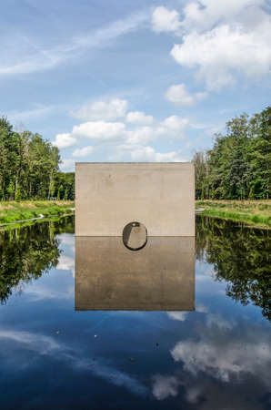 Kraggenburg, The Netherlands, August 4, 2019: the end facade of the concrete "Deltagutter", former experimental hydraulic facility, in Waterloopbos national monumentのeditorial素材