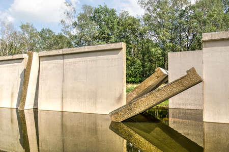 Kraggenburg, The Netherlands, August 4, 2019: detail of the concrete "Deltagutter", former experimental hydraulic facility, with opened sections, in Waterloopbos national monumentのeditorial素材