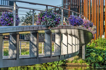 Zwolle, The Netherlands, July 24, 2019: close-up of the double arc construction of Spinhuis pedestrian bridge decorated with season's flowersのeditorial素材