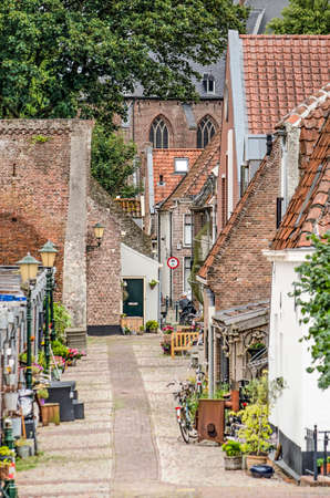 Elburg, The Netherlands, August 3, 2019: street in the old fortified town, paved with cobble stones and lined with brick and white plastered housesのeditorial素材