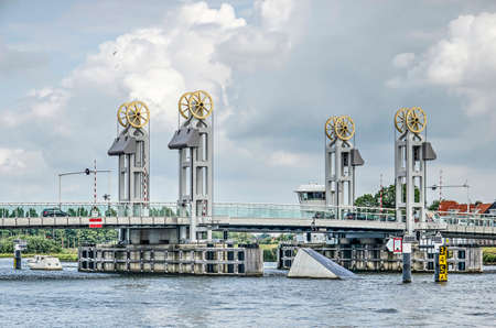 Kampen, The Netherlands, July 31, 2019: view across the river IJssel towards the striking design of the city bridge under a dramatic skyのeditorial素材
