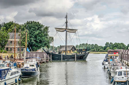 Kampen, The Netherlands, July 31, 2019: visitors marina with modern yachts as well as a reconstructed wooden historic "Kogge" ship from the Hanze eraのeditorial素材