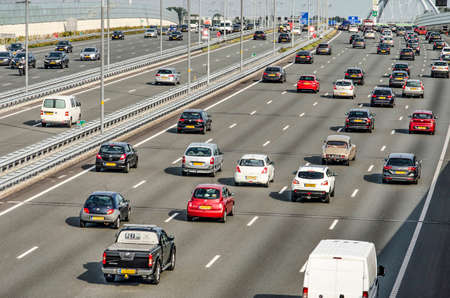 Muiden, The Netherlands, August 21, 2019: view of the A1 motorway just outside of Amstermdam during evening rush hour with a total of twelve lanes of busy trafficのeditorial素材