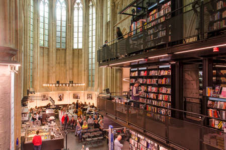 Maastricht, The Netherlands, September 8, 2019: interior view of the Dominican church, converted to a bookstore, with floors and bookshelves in the nave and a cafe in the chancel arreaのeditorial素材