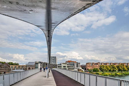Maastricht, The Netherlands, September 7, 2019: view under the arch of the modern Hoge Brug (High Bridge) for pedestrians and bicyclesのeditorial素材