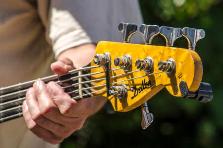 The Hague, The Netherlands, July 8, 2019: fingers touching the strings of a five string bass during an open air jam session on a sunny dayのeditorial素材