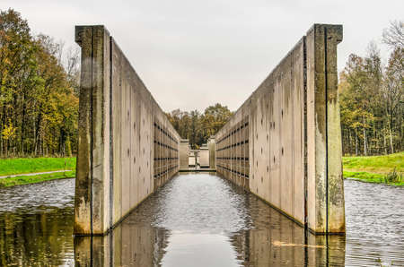 Marknesse, The Netherlands, November 9, 2019: view along the length of the concrete Deltawerk, a former hydraulic experimental facility in Waterloopbos national monumentのeditorial素材