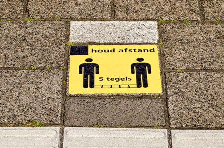 Rotterdam, The Netherlands, May 28, 2020: yellow sticker on platform at Laan van NOI railway station...