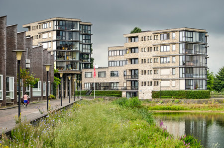 Zwolle, The Netherlands, August 2, 2020: recently built apartment buildings and quay houses facing lake Milligerplasのeditorial素材
