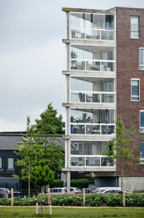 Zwolle, The Netherlands, August 2, 2020: residential building in Stadshaven neighborhood with triangular closed verandasのeditorial素材