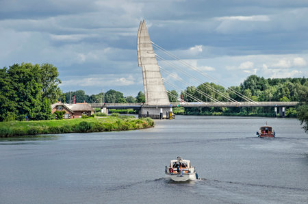 Zwolle, The Netherlands, July 21, 2020: small yachts on Zwartewater river, crossed by Mastenbroeker bridgeのeditorial素材