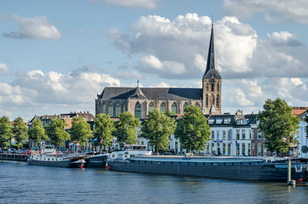 Kampen, The Netherlands, July 26, 2020: Medieval Bovenkerk church towering above the waterfront of the old town and the IJssel riverのeditorial素材