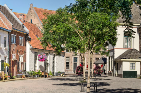 Hattem, The Netherlands, July 31, 2020: the picturesque Krkplein (church square) with trees, and...