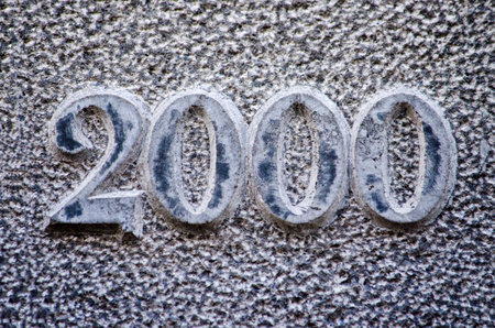 Date-stone in a rough blueish stone material with the year 2000 embossedの写真素材