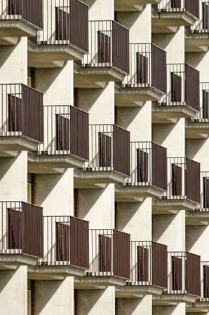 Lansingerland, The Netherlands, August 29, 2020: sun, shadow, balconies and separation walls creating a geometric pattern on the facade of an apartment buildingのeditorial素材