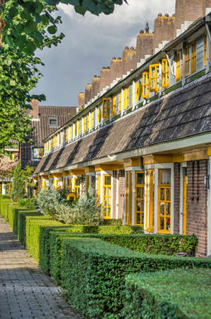 Delft, The Netherlands, August 23, 2020: row of historic townhouses in Amsterdam School style, in the 1920's extension of garden village Agnetaparkのeditorial素材