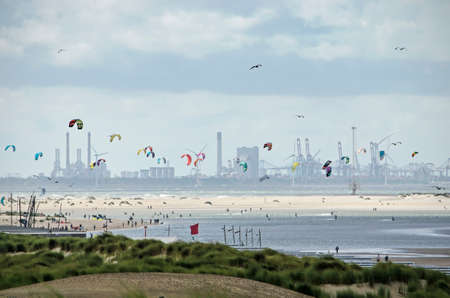 The Hague, The Netherlands, August 29, 2020: long distance view along the sandy coast towards Maasvlakte industrial area, with beach, dunes and kitesurfersのeditorial素材