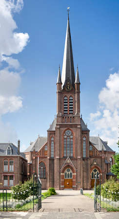 Wateringen, The Netherlands, August 23, 2020: the neo-gothic roman catholic church of Saint John the Baptist against a blue skyのeditorial素材