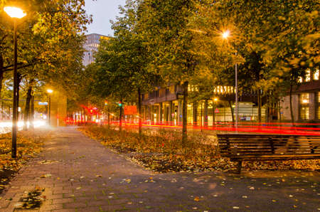Rotterdam, The Netherlands, October 28, 2020: the pedestrian strip in the middle of blaak boulevard at dusk, with lighttrails at both sidesのeditorial素材