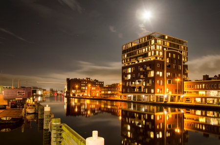 Haarlem, The Netherlands, November 19, 2021: night view along the river Spaarne with on its eastbank a new neighborhood developed in a former industrial areaの写真素材
