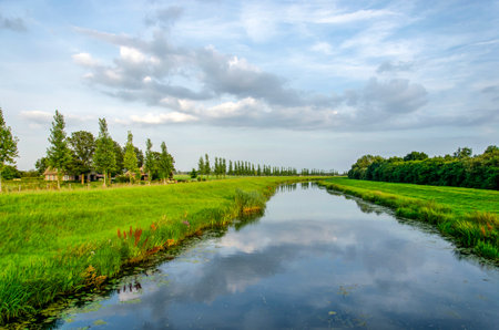 Canal near Zwolle, The Netherlands under a beautiful evening skyの写真素材