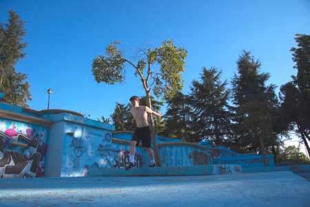 young male athlete doing parkour jumps and acrobatic exercises in the urban area of ââââa city category urban gymnasticsの写真素材