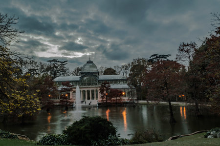 sunset with the background the crystal palace of the retiro park in the city of madrid landscape photographyのeditorial素材