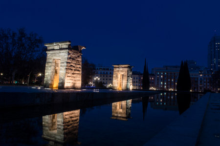 sunset view at the temple of debod in the city of madrid with reflections in the water urban...