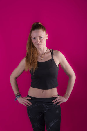 woman with long blond hair performing a yoga posture moving her hands image with purple background photography happinessの写真素材