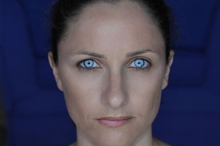 portrait of a female with a blank expression and piercing blue eyesの写真素材