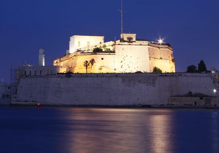 fort st angelo, an ancient fortification in malta  taken at dusk with top part illuminated