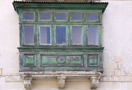 old derelict wooden maltese balconyの写真素材