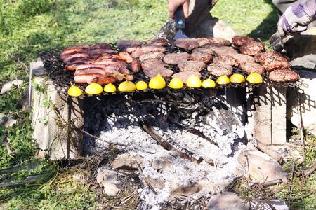 a man made bbq built with bricks and a metal brick using wood for fireの写真素材