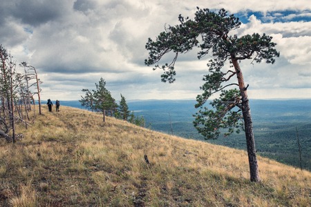 Two hikers traveling along the ridge on the southern Uralsの写真素材