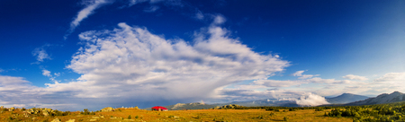 Panorama of highland plateau with weather station house, National Park Taganaiの写真素材