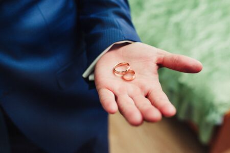 wedding rings on groom's handの写真素材