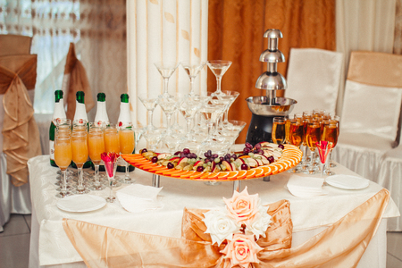 Decorated table for a festive Banquet, with drinks and fruitsの写真素材