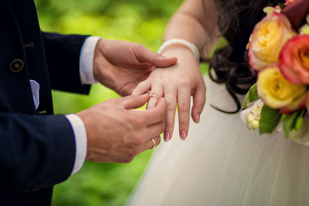 The bride putting the groom's finger ringの写真素材