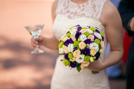 Bride with a classical wedding bouquet of white flowersの写真素材