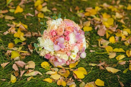 Wedding bouquet of colorful flowers lying on the grassの写真素材