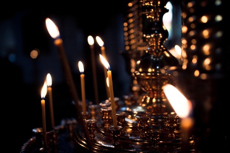 Candles burn in the Church