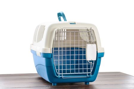 Plastic cage carrying for dogs and cats isolated on white. Travel transportation, veterinary clinic and pet care conceptの写真素材