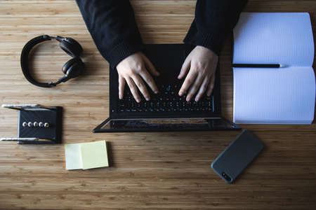 Remote work kit on wooden office deskの写真素材